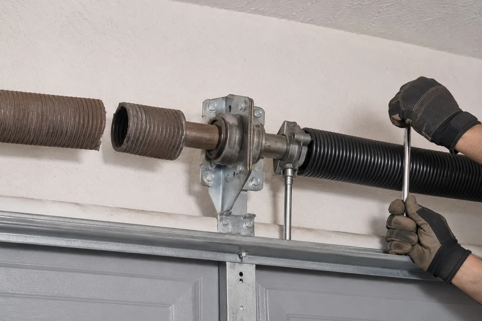 Broken and replacement garage door torsion springs