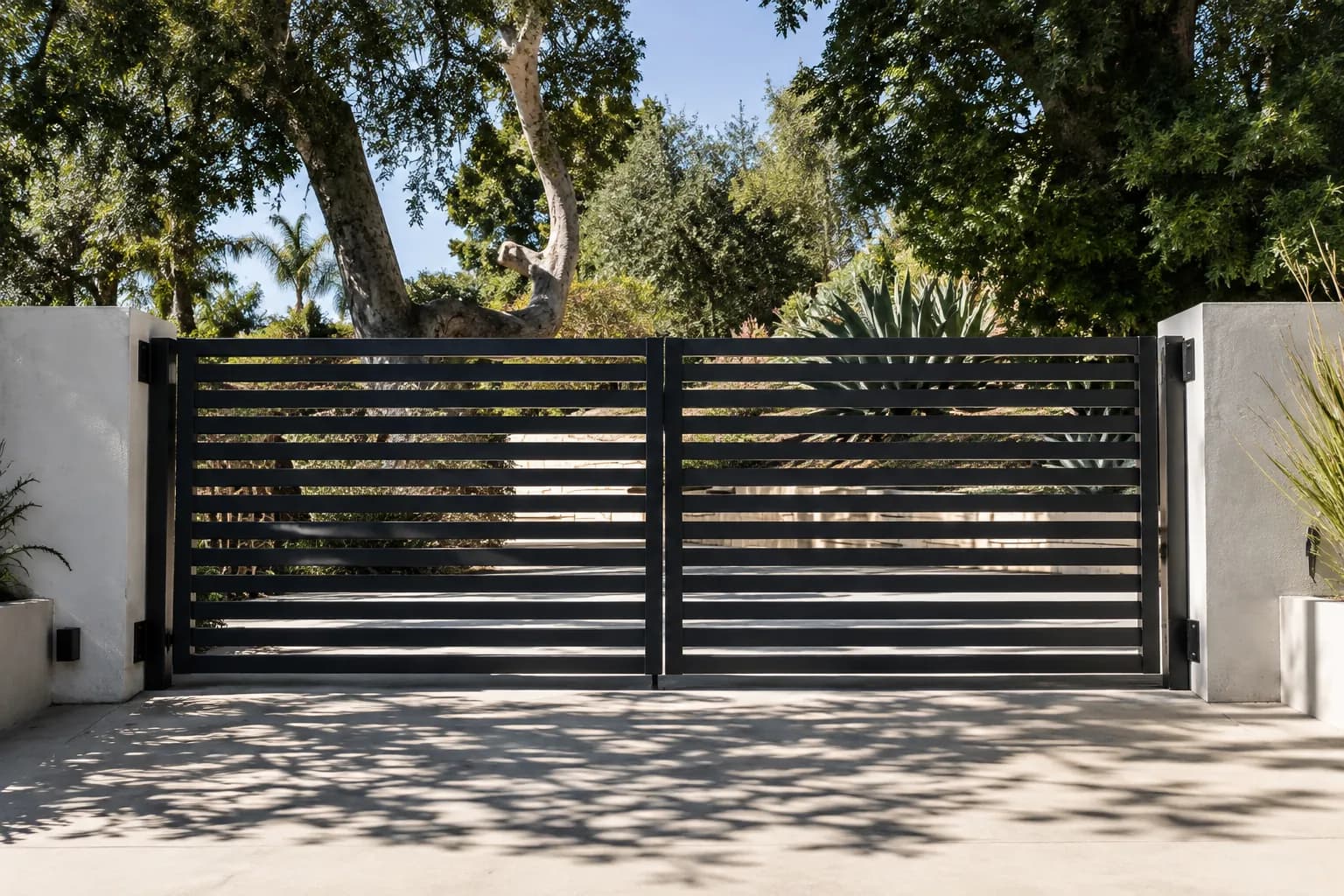 Modern automated driveway gate with black horizontal slats